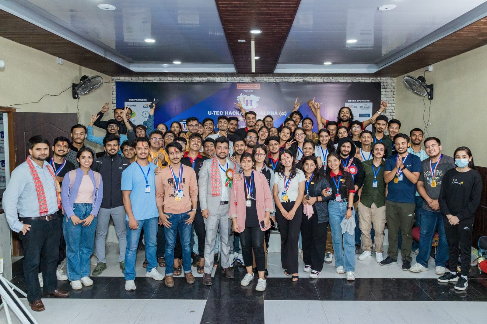 A large group of club members and participants posing together in the event hall