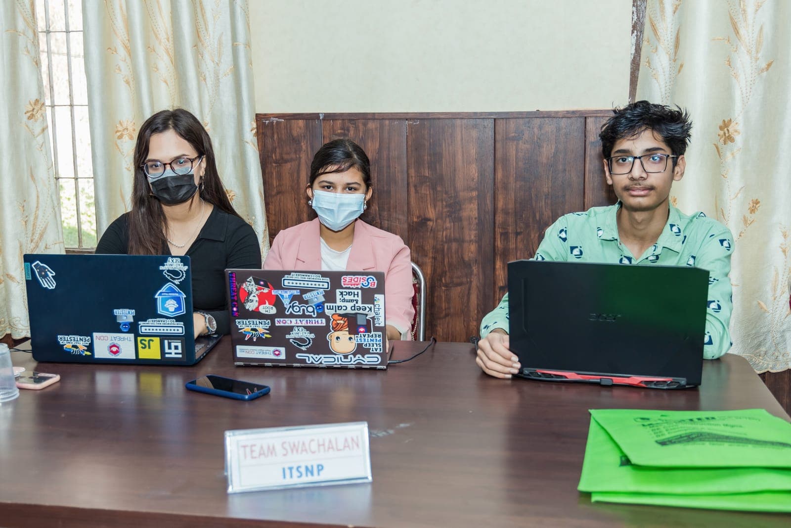 A team coding at their table during U-TEC Hackathon Alpha