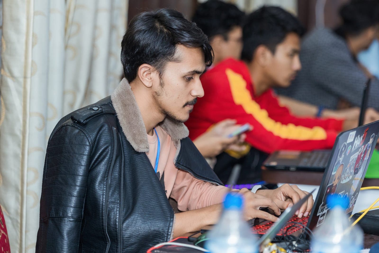 Participants coding during U-TEC Hackathon Alpha