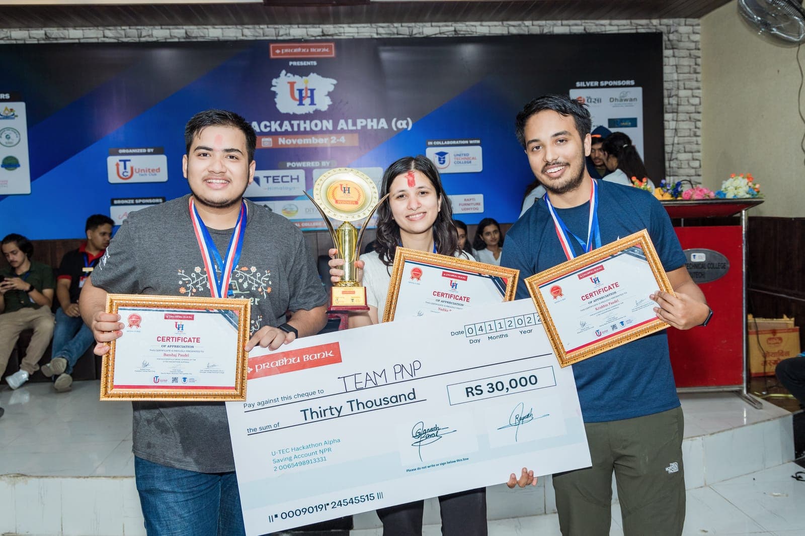 The winning team receiving their prize at U-TEC Hackathon Alpha