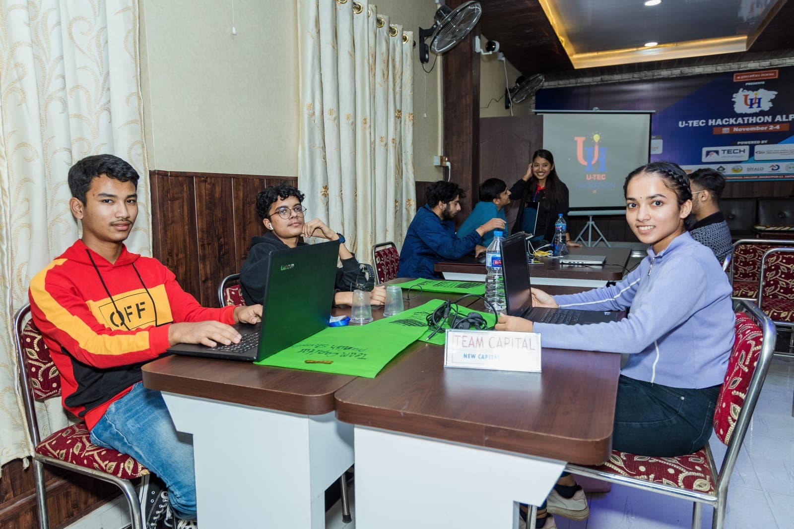 Teams setting up at their tables on day one of U-TEC Hackathon Alpha