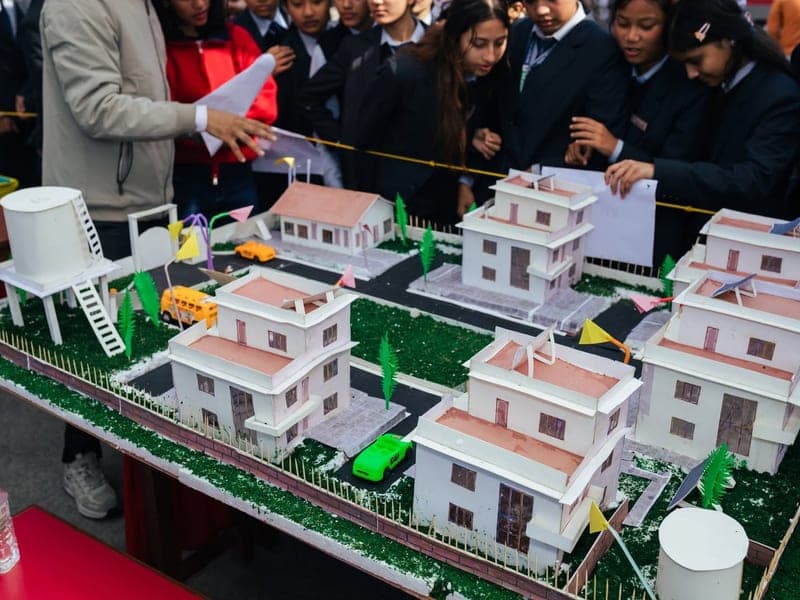 Visitors around a student-built township model at United Tech Fusion 2082