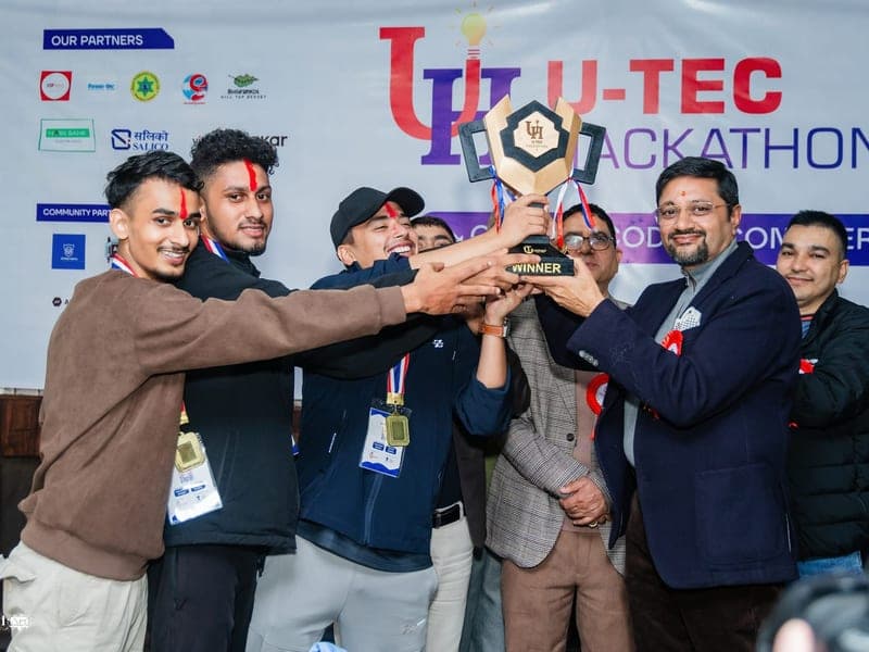 Hackathon winners lifting the trophy