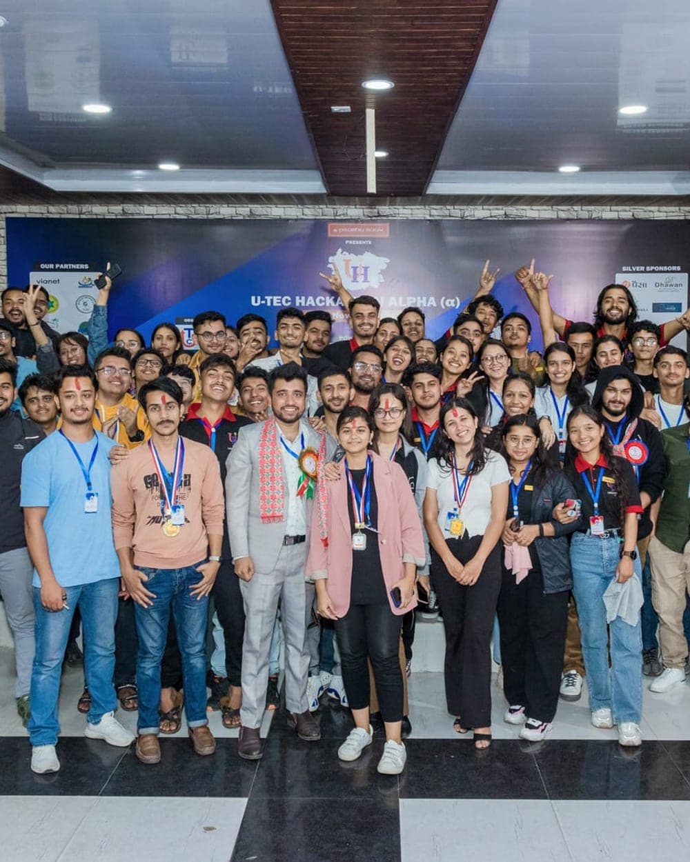 United Tech Club members and participants posing together at a hackathon